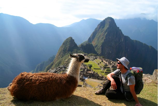 Man with llama in front of Machu Picchu - Peru Tours - South America Tours - On The Go Tours