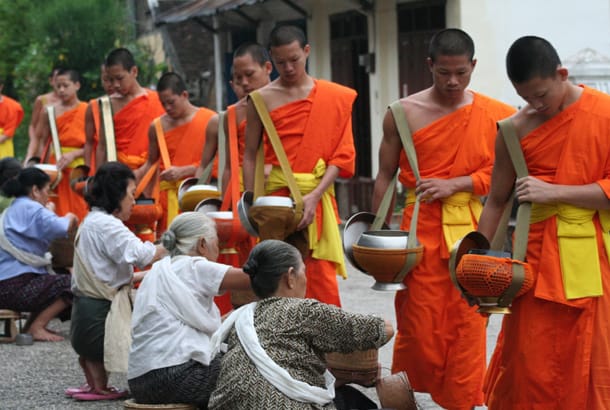 Procession of monks in Laos - On The Go Tours