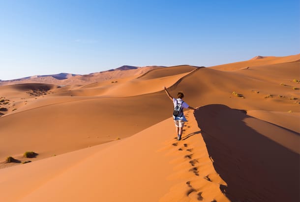 Solo female traveller on Namibian sand dunes - On The Go Tours