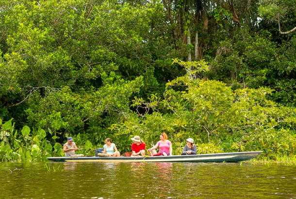 Tourists on a canoe in the Ecuadorian Amaozn jungle