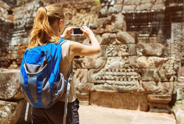 Woman taking a photo in Angkor
