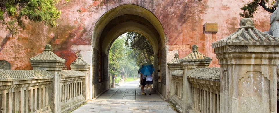 Pastel pink archyway at the end of a bridge in Qufu