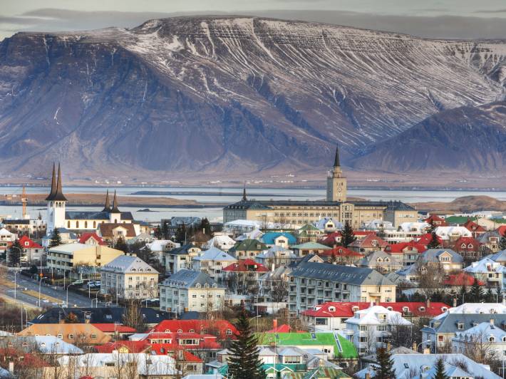 Aerial view of Reykjavik city with sea and Esja volcanic mountain range in background, Iceland