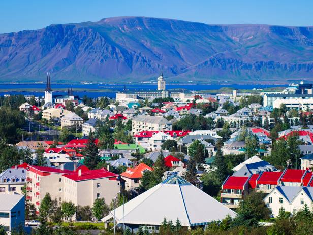 Colourful houses of Reykjavik against a backdrop of snowy mountains