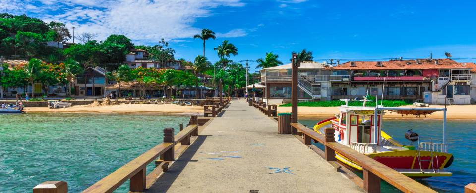 Boardwalk over crystal clear blue water in Amacao Dos Buzios
