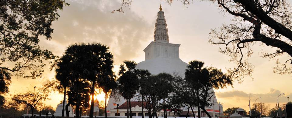 The setting sun behind a temple in Anuradhapura