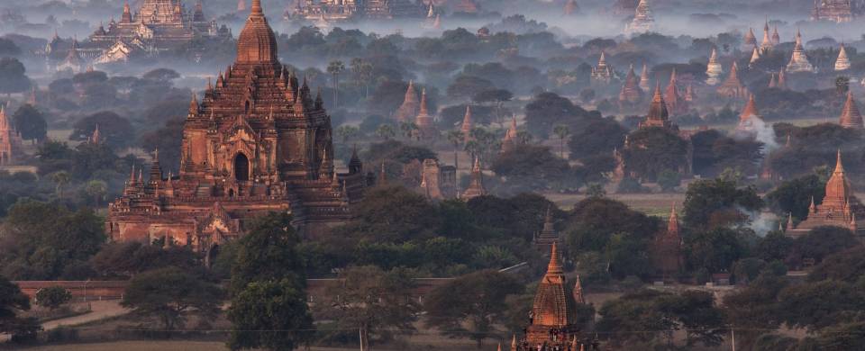 Temples of Bagan at dawn, surrounded by wisps of cloud