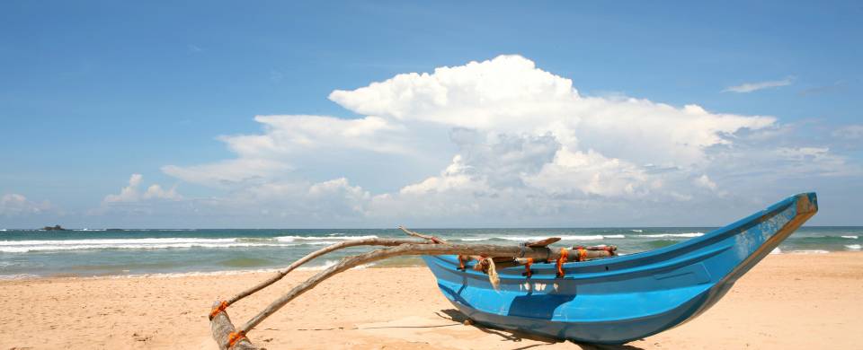 Traditional Sri Lankan boat on the sandy beach in Bentota and Beruwala