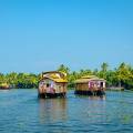 Wooden boat drifting along the river in Kumarakom