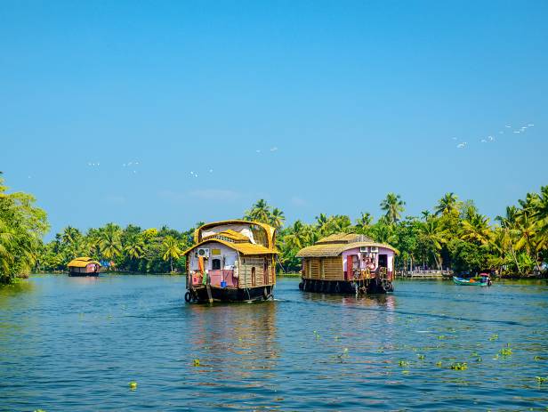 Wooden boat drifting along the river in Kumarakom