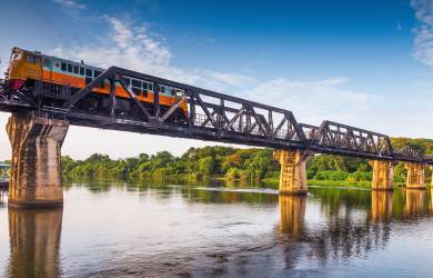A train makes its way across the infamous Bridge over the River Kwai in Kanchanaburi, Thailand