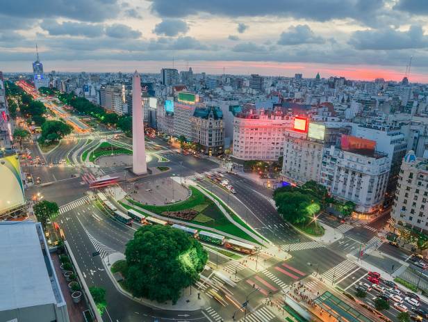 Bright lights of the cityscape behind boats on the hardbour in Buenos Aires