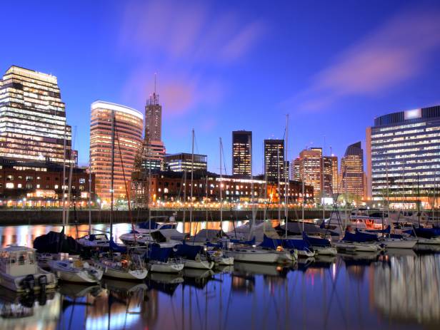 Bright lights of the cityscape behind boats on the hardbour in Buenos Aires