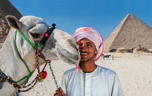 Camel man and Pyramids of Giza - Egypt Tours - On The Go Tours