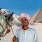 Camel man and Pyramids of Giza - Egypt Tours - On The Go Tours