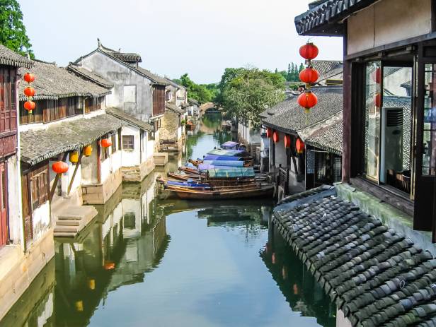 View of Suzhou lit up at night from across the water