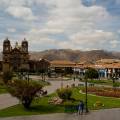 Looking out across the rooftops around the Plaza de Armas in Cuzco with the Andean mountains in the 