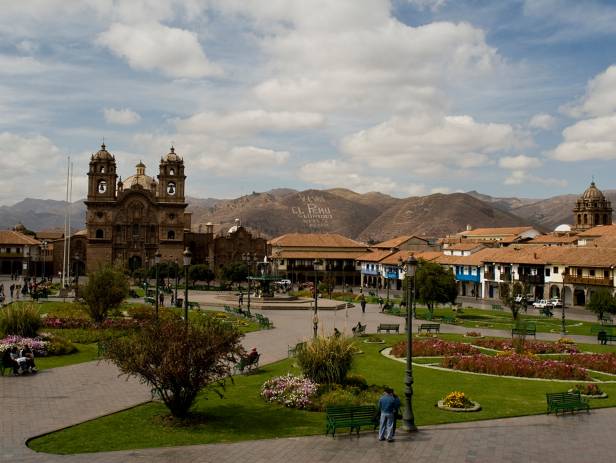 Looking out across the rooftops around the Plaza de Armas in Cuzco with the Andean mountains in the 