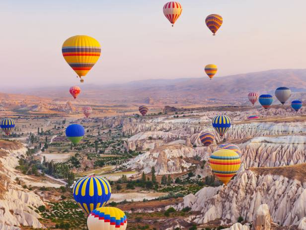Hot air balloons floating over the stunning landscape of Cappadocia