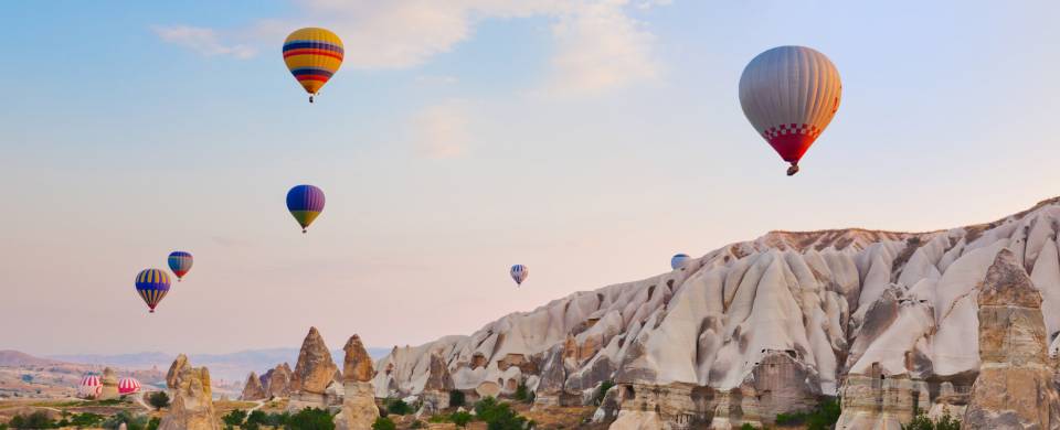 Hot air balloons floating over the stunning landscape of Cappadocia