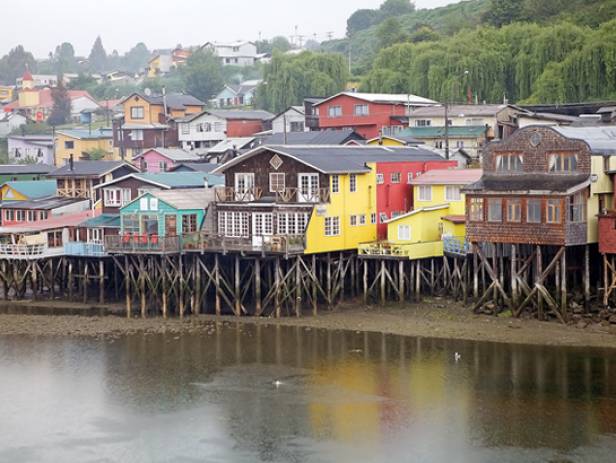 View of houses on stilts along the waterfront of Chile