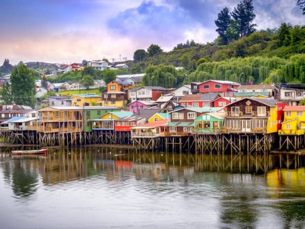 View of houses on stilts along the waterfront of Chile