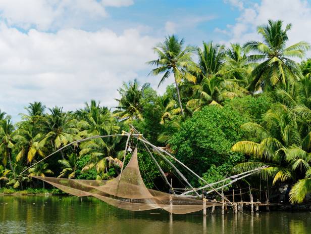 Wooden boat drifting along the river in Kumarakom