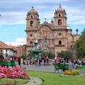 Looking out across the rooftops around the Plaza de Armas in Cuzco with the Andean mountains in the 