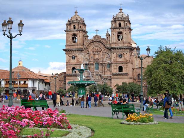 Looking out across the rooftops around the Plaza de Armas in Cuzco with the Andean mountains in the 