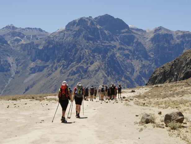 Man standing at the edge of a cliff in the Colca Canyon