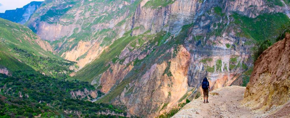 Man standing at the edge of a cliff in the Colca Canyon