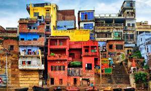 Colourful buildings on the River Ganges - India Tours - On The Go Tours