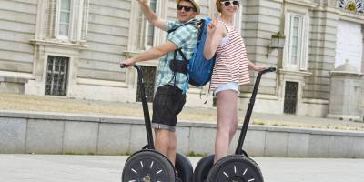 A couple of tourists riding a Segway in Madrid, Spain