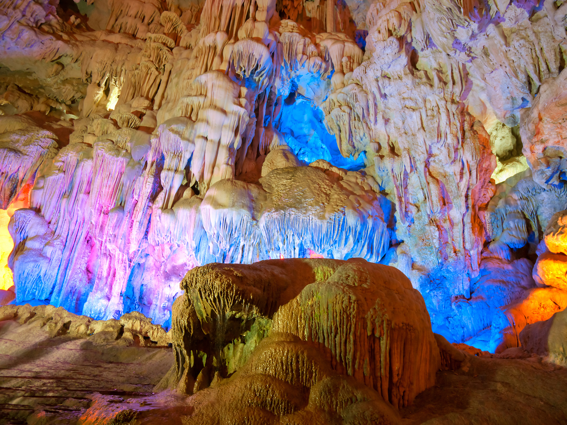 a cave illuminated with multicolored lights