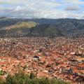 Looking out across the rooftops around the Plaza de Armas in Cuzco with the Andean mountains in the 