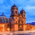 Looking out across the rooftops around the Plaza de Armas in Cuzco with the Andean mountains in the 