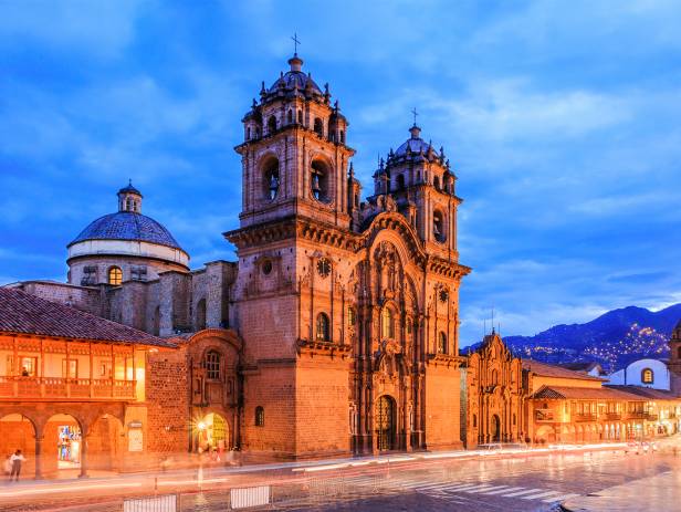 Looking out across the rooftops around the Plaza de Armas in Cuzco with the Andean mountains in the 