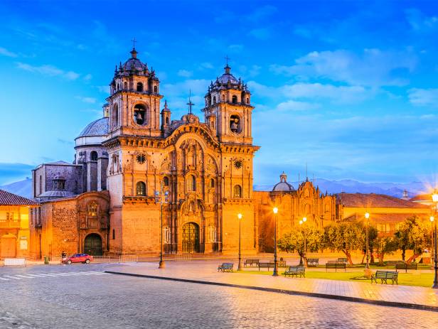 Looking out across the rooftops around the Plaza de Armas in Cuzco with the Andean mountains in the 