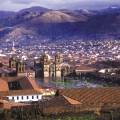 Looking out across the rooftops around the Plaza de Armas in Cuzco with the Andean mountains in the 