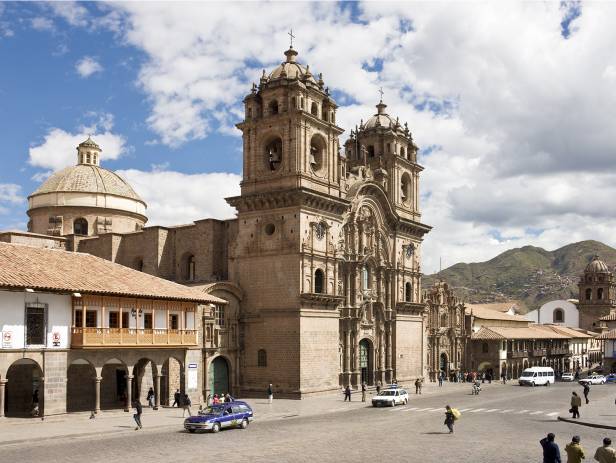 Looking out across the rooftops around the Plaza de Armas in Cuzco with the Andean mountains in the 