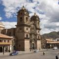 Looking out across the rooftops around the Plaza de Armas in Cuzco with the Andean mountains in the 