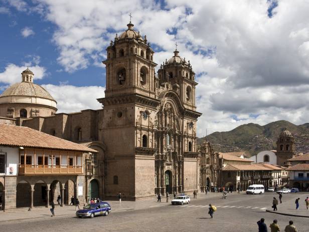 Looking out across the rooftops around the Plaza de Armas in Cuzco with the Andean mountains in the 