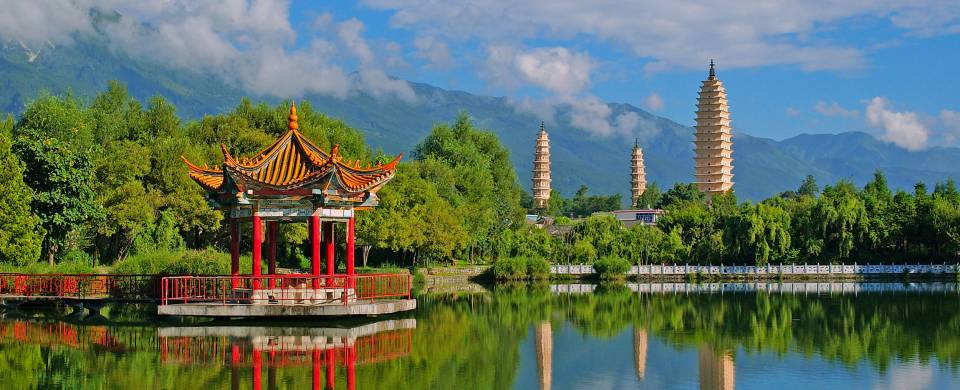 A temple of the waterfront, surrounded by lush foliage, in Dali