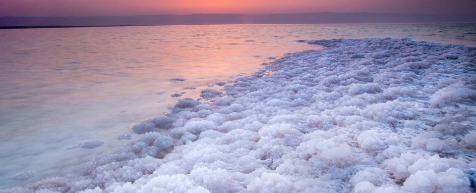 Salt encrusted rim of the Dead Sea at sunset