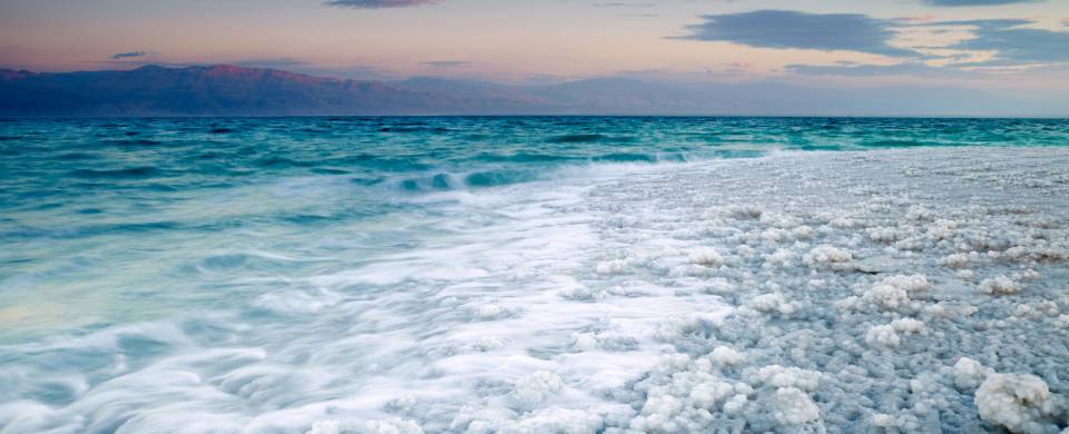 Salt crystals along the shore of the sparkling Dead Sea