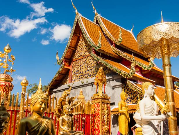 White Buddha statue in front of one of the many temples of Chiang Mai