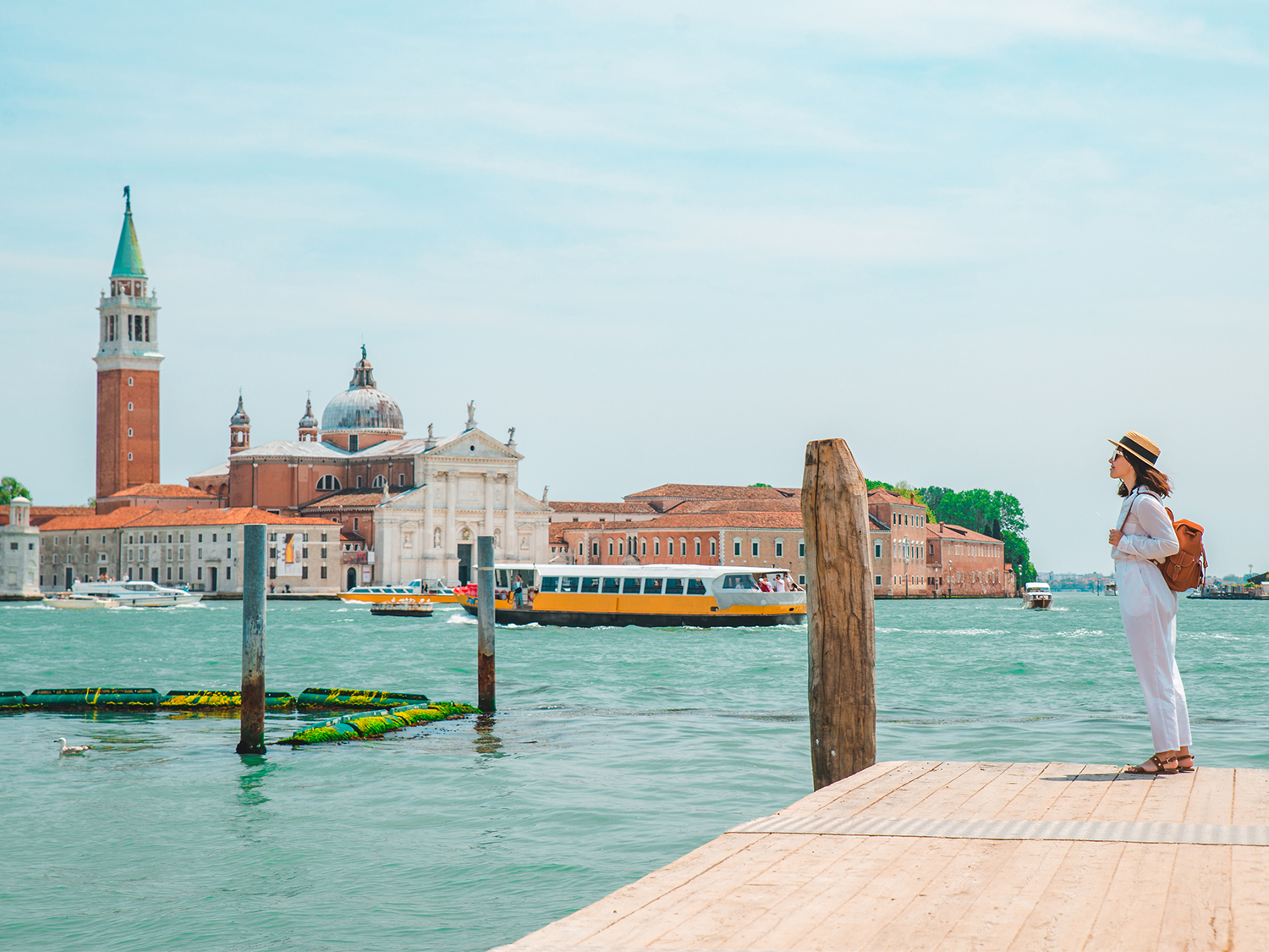A lady at the edge of a canal in Venice, Italy