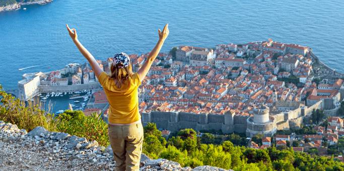 A woman enjoys panoramic views over Dubrovnik | Croatia 