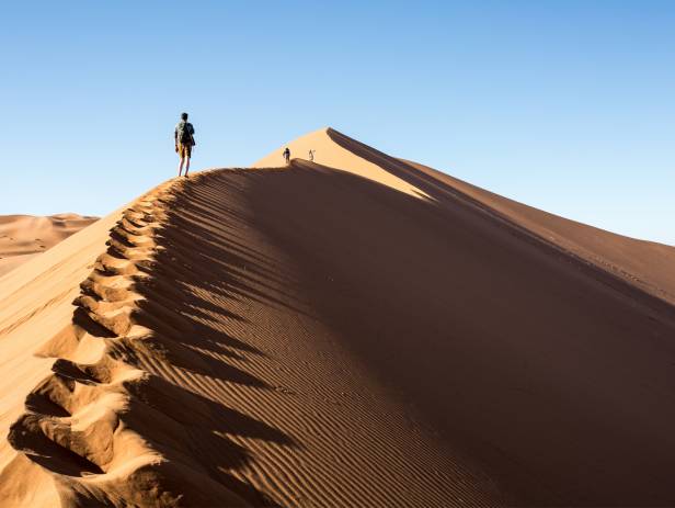 Orange sand dunes stretching into the distance at Sesriem