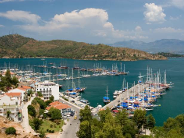 The town of Fethiye perched on the side of a mountain, overlooking to water